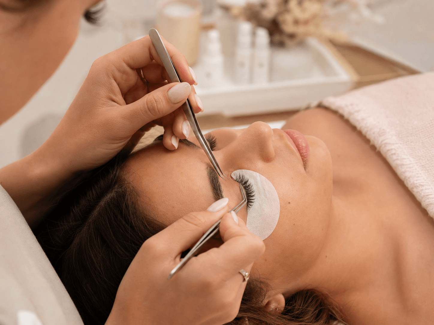 Lash artist applying eyelash extensions at Jay Lash and Brow, St Ives